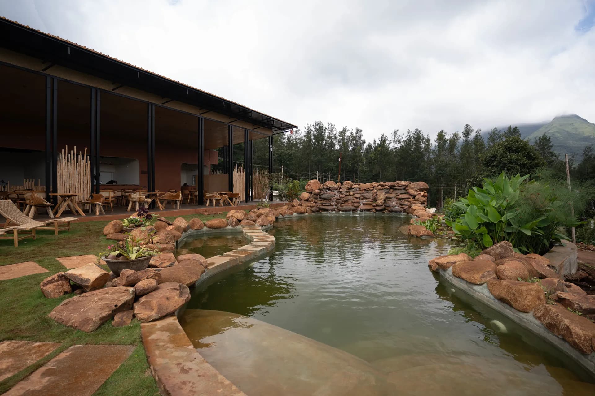 The Nava pavilion across the Bio Pool, with the Mullayanagiri peaks beyond