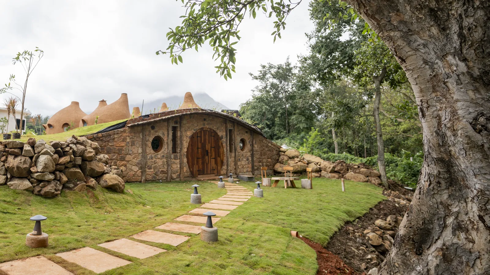 The Burrow — exterior, the round door beneath the tree