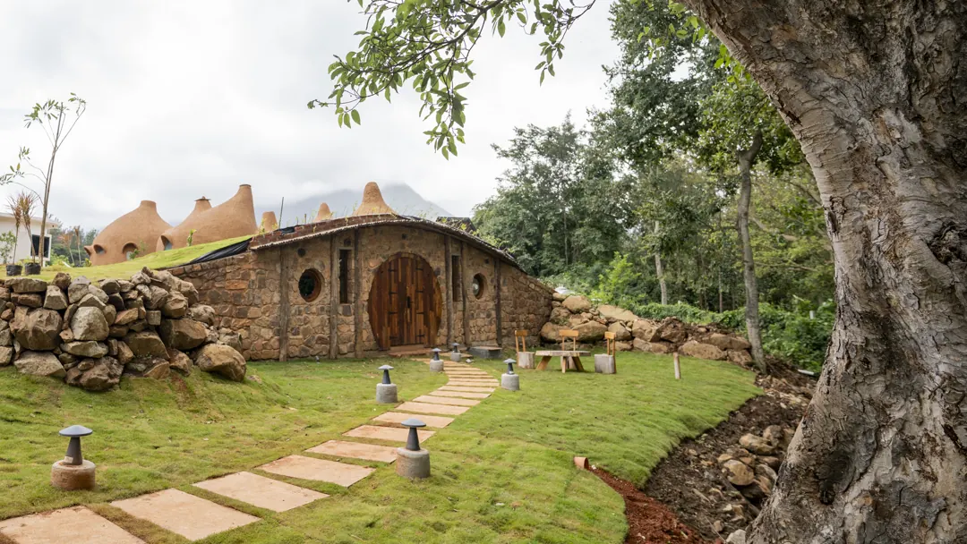The Burrow — exterior, the round door beneath the tree