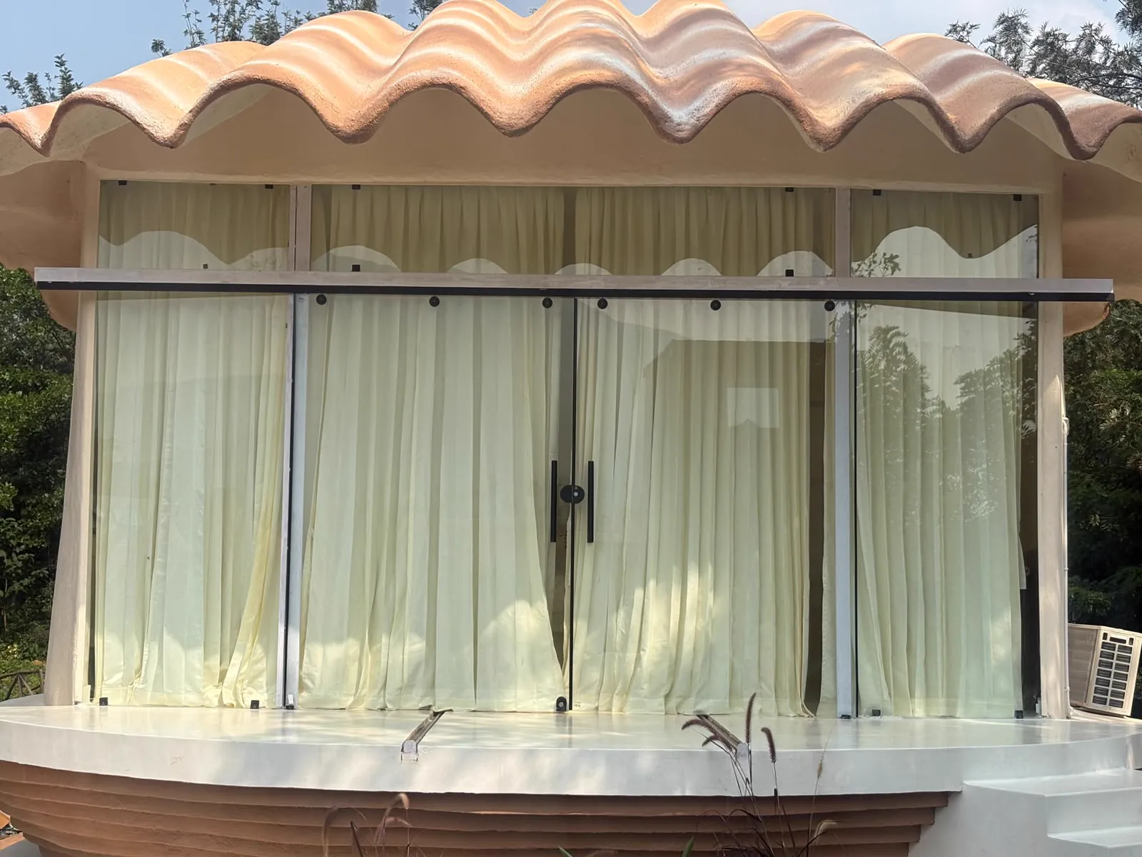The Shore — exterior, the shell opening onto the garden