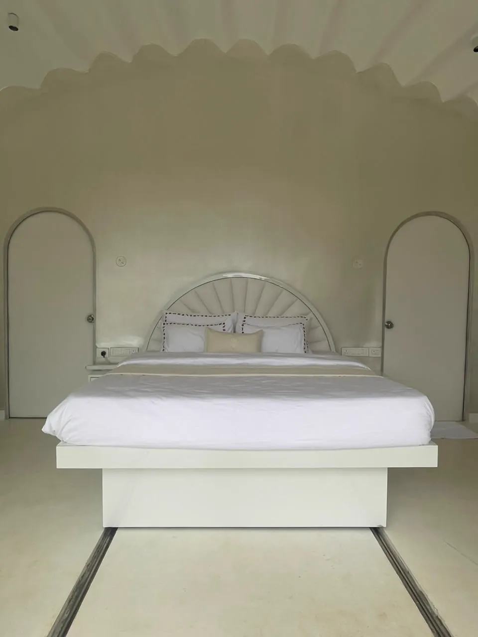 The Shore — the bed beneath its shell-shaped headboard